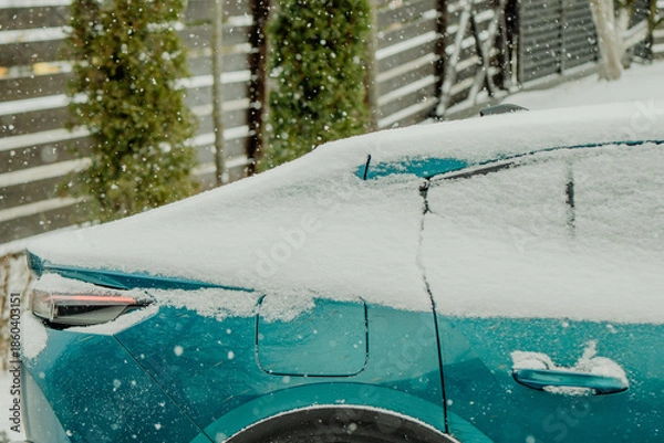 Obraz Brushing Snow Off a Car Windshield in Winter