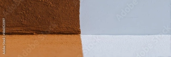 Fototapeta オレンジと白の壁の塗装作業の様子