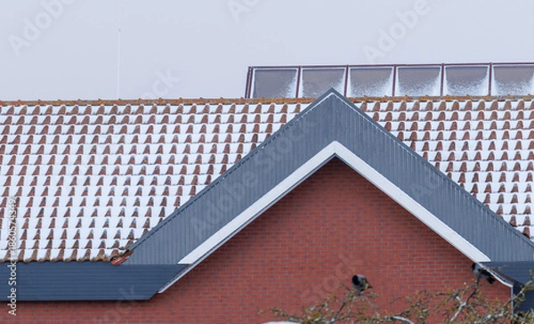 Obraz Snow covered tiled rooftops in winter