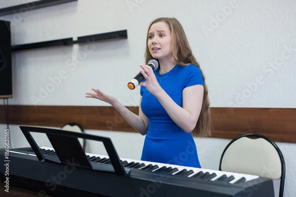 Obraz Caucasian woman singing into microphone. 