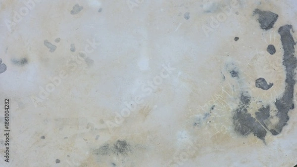 Obraz An old and aged concrete floor surface. It features visible signs of damage, peeling paint, water stains, and dark mold marks. The rough, grunge texture is ideal for vintage design backgrounds.