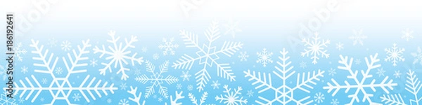 Fototapeta Snowflakes on blue gradient background.