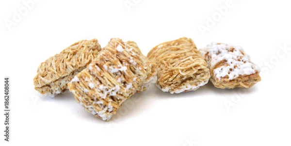 Fototapeta Breakfast setting with frosted wheat cereal on white background 