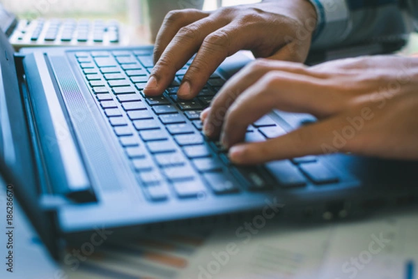 Fototapeta Hand typing on keyboard laptop.Businessmen chat with a partner. Businessmen contact with a partner for business.