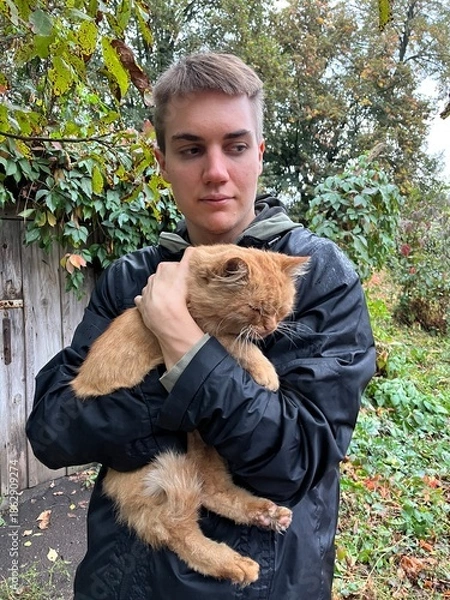 Fototapeta young man with cat