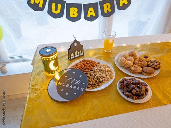 Obraz Eid Mubarak table with Ramadan sweets, dates, nuts and festive decor
