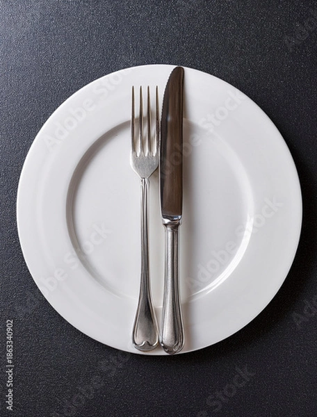 Obraz plate and fork on black background
