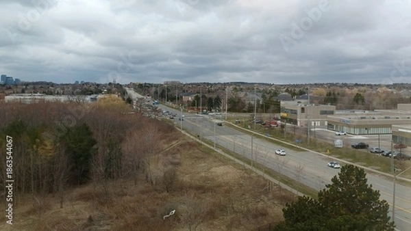 Obraz Suburban landscape under cloudy sky.