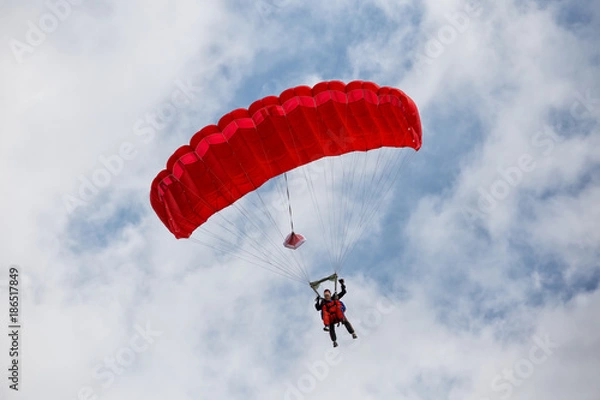 Obraz Parachuter descending with a red parachute