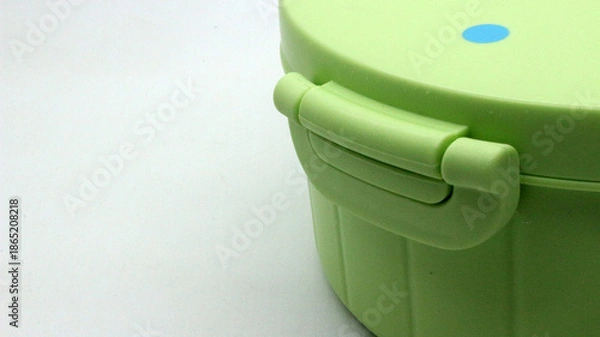 Obraz Green plastic lunch box on white background.