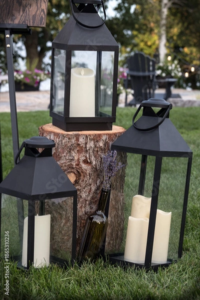 Obraz Three candle lanterns in a garden
