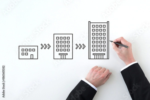 Obraz 会社を大きく発展させるイメージを描くビジネスマンの手