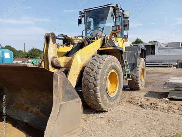 Obraz Yellow wheel loader at a construction site, vector illustration