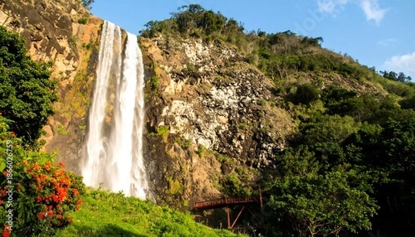 Obraz Waterfall cascading down rocky hillside