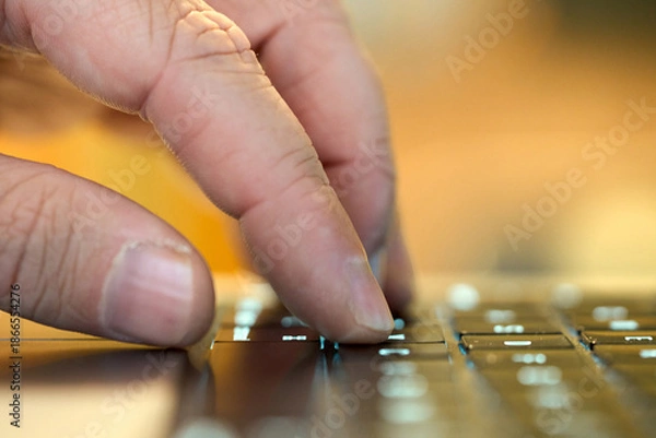 Obraz Hand typing on a keyboard while working