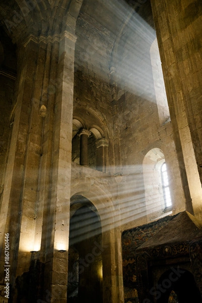 Obraz Light Beams Streaming Through Window in Ancient Stone Cathedral Interior