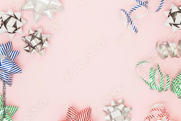 Obraz Festive copy space with wrapping pull bows on pink background. Holiday and sales flat lay concept, top view.