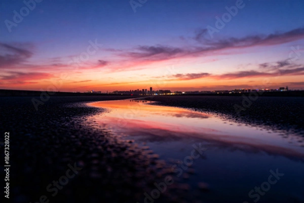 Obraz Sunset Over River with City Skyline Reflection