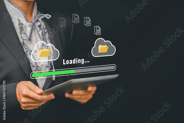 Obraz Business professional using a tablet with cloud computing and document transfer icons, symbolizing digital technology and data management.