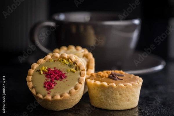 Obraz Sweet mini tartlets on black table.
