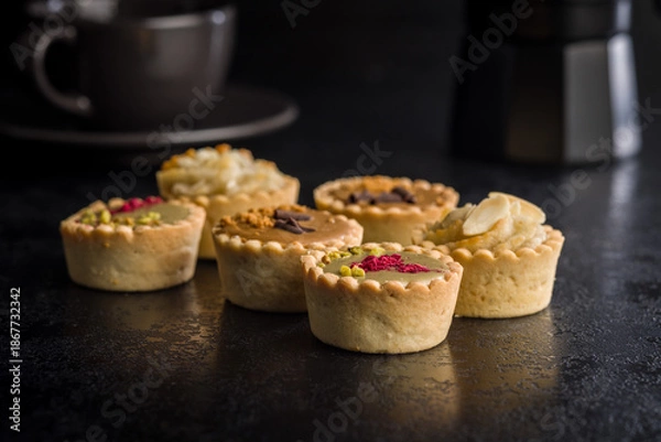 Obraz Sweet mini tartlets on black table.
