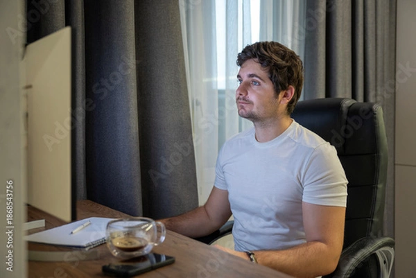 Obraz Focused worker at home workstation with computer and cup