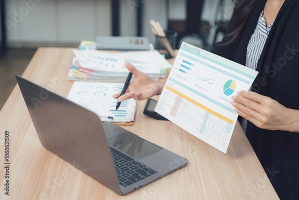 Obraz Data analysis work at Desk: A professional focused on a screen, analyzes data, interpreting complex information and finding solutions in office.