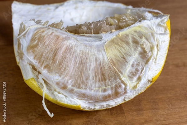 Obraz A peeled grapefruit slice. An orange slice on the table.