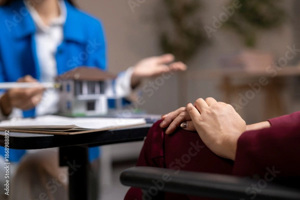 Obraz Real estate agent discussing house model with client