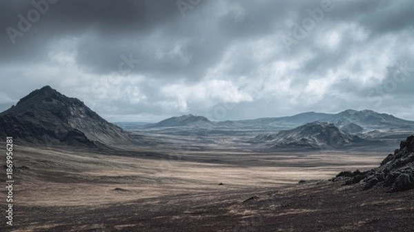 Obraz Dramatic cloudy landscape with rugged mountains and vast open plains