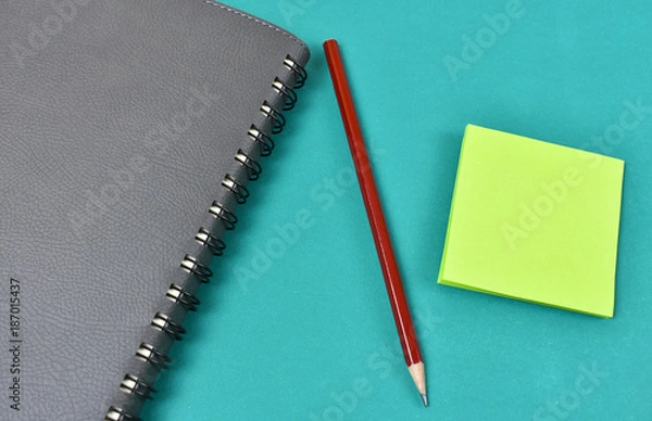 Obraz Notepad for notes, pencil and stickers on the table for the meeting