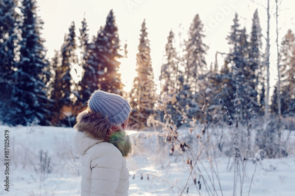 Obraz portrait of a girl in profile in the winter forest at sunset