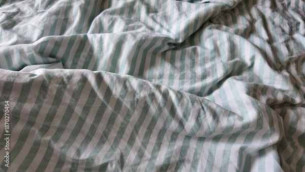 Obraz Bed sheets with stripes on a messy bed