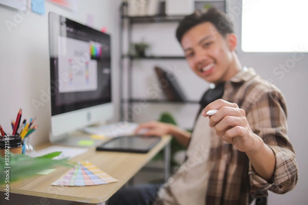 Obraz Creative Professional Sketching Initial Logo Ideas on Paper While Referencing Digital Design