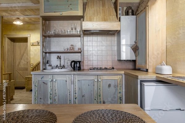 Obraz Rustic kitchen interior with hand-painted wooden cabinets