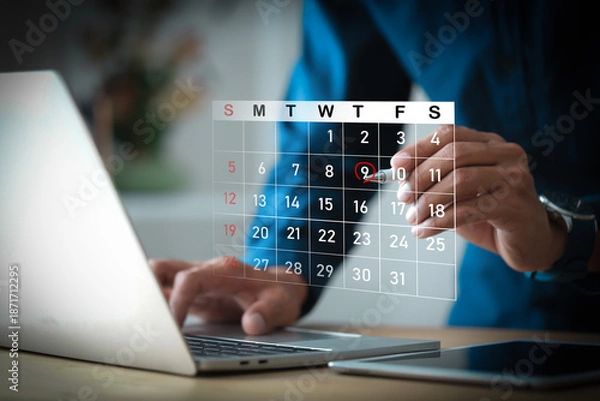 Obraz Businessman hands using laptop computer with virtual calendar interface for appointment scheduling.