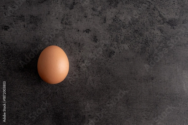 Fototapeta egg on a dark background with negative space