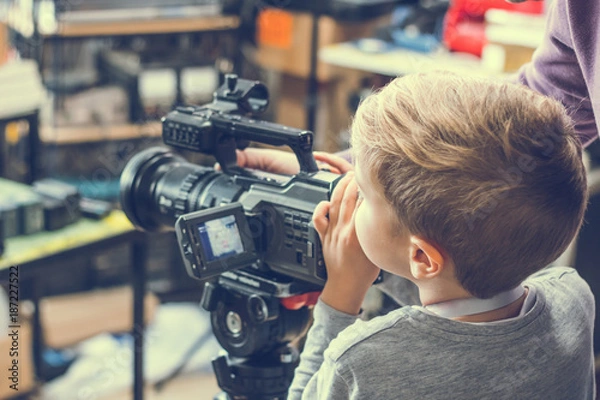 Obraz Small boy filming with video camera.