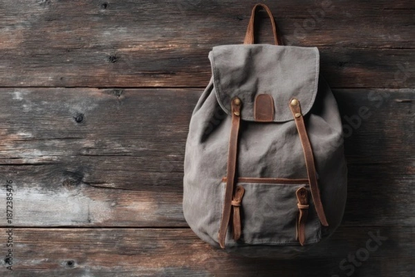 Obraz Gray canvas backpack on rustic wooden planks (1)