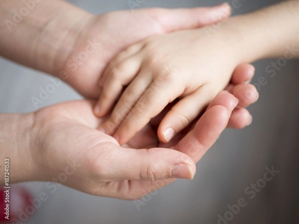 Fototapeta mother holding baby hand