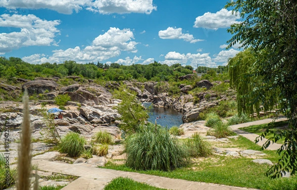 Obraz A path leads through a grassy area with a small stream