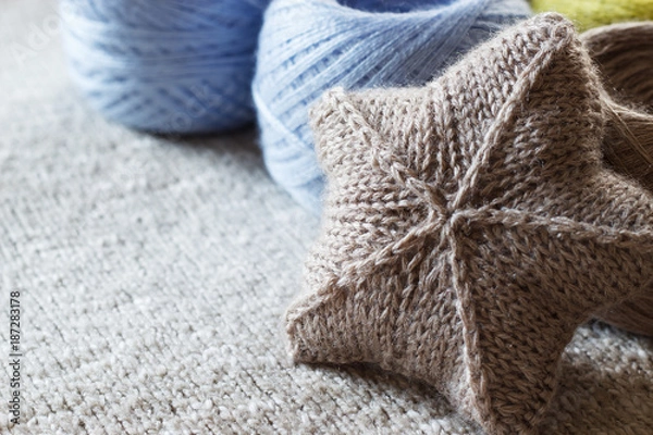 Fototapeta A yarn for hand knitting and a knitted item. Copy space. Selective focus.