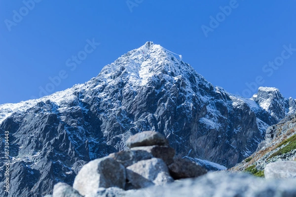 Obraz Winter landscape of snow mountain range and blue sky. Scenery background for mountain activities such as skiing trekking winter