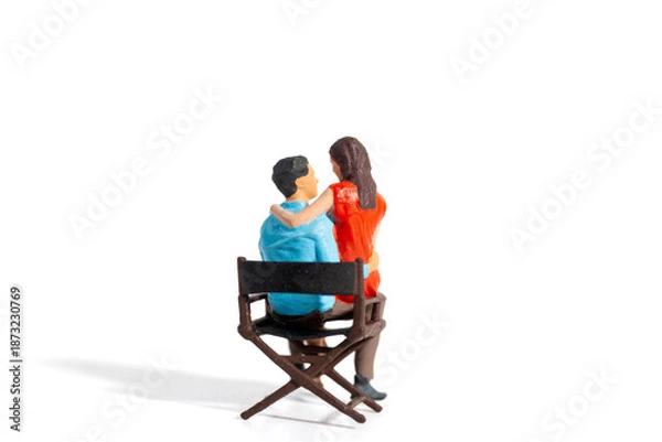 Obraz Miniature Couple Embracing While Sitting Together