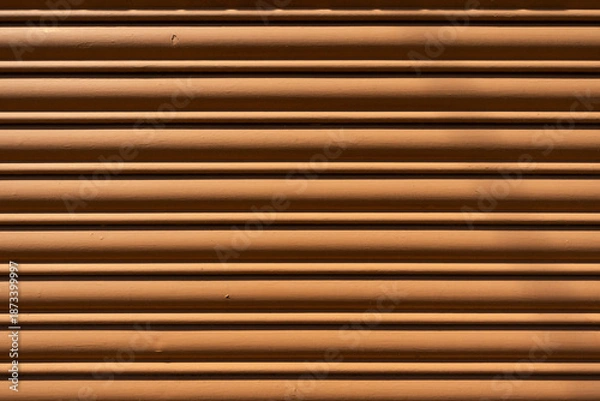 Fototapeta Brown metal roller shutter with horizontal lines