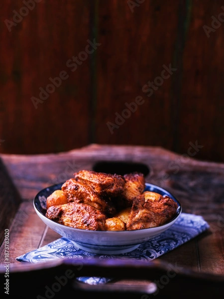 Obraz Fried chicken wings with potatoes on a rustic background. Soft focus.
