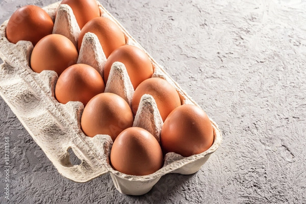 Fototapeta Farm raw fresh egg in pack on gray table scrambled eggs omelet fried egg