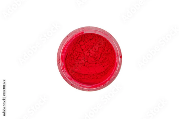 Fototapeta Red pigment for manicure. Beautiful bright red powder for summer, spring, nail design. Loose paint in a small glass jar on a white background.