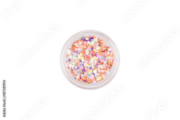 Fototapeta Confetti for manicure. Round beautiful sequins for nail design in manicure and pedicure. Decorative particles. Fish scales for decoration. Pink, purple, coral, blue in a small glass jar.