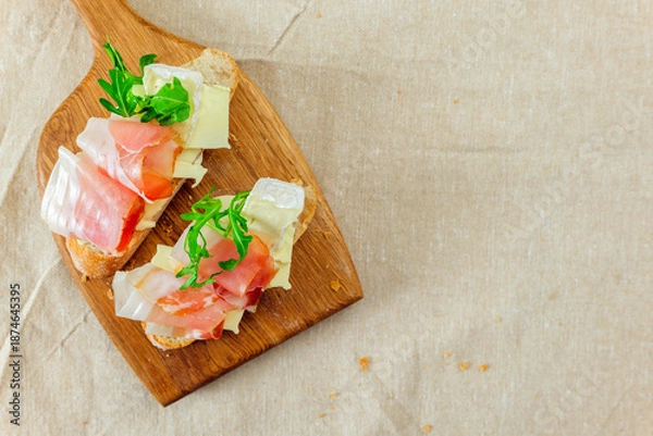 Obraz Sliced bread topped with cheese and vegetables